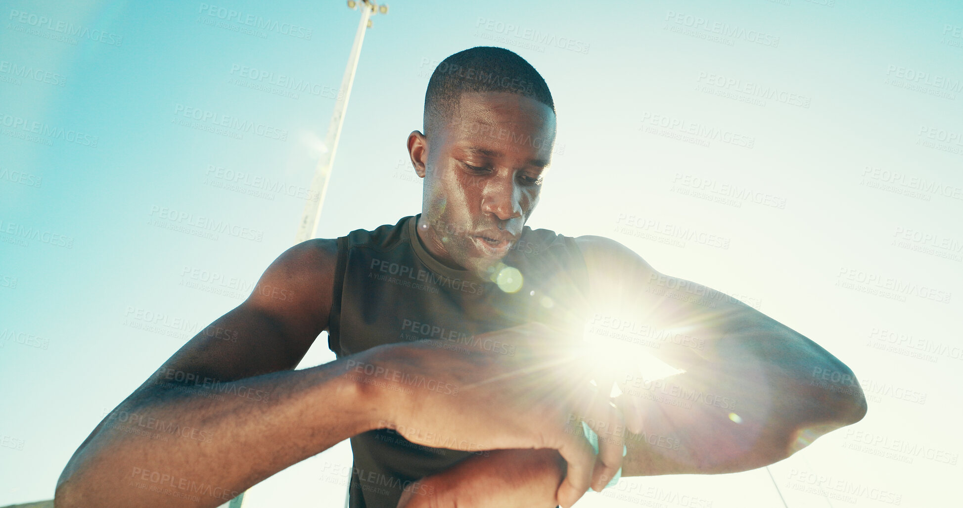 Buy stock photo Black man, runner and smart watch in city for exercise, stats or break with low angle for training. Person, athlete and heart rate with timer, stopwatch and app with sweat, workout and tired in Kenya
