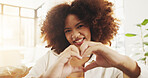 Hands in heart, home and portrait of black woman with smile for relaxing, happy and social media. Living room, apartment and face of person with gesture, emoji and sign for love, romance and flirt
