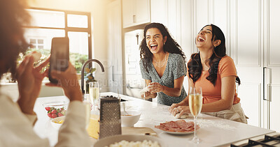 Buy stock photo Laughing, photography and cooking with friends in kitchen for help, bonding and support. Food, memory and dinner with group of women and meal prep in home for wine, reunion and party together