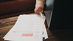 Warning, documents and person on laptop for finance, online banking and debt review in home. Invoice, digital payment and hands on computer with paperwork for financial bills, mortgage and budget