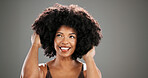 Haircare, beauty and woman with afro in studio with healthy texture, growth results or volume. Mockup space, african person or confidence with hairstyle on gray background for grooming or maintenance