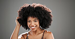 Woman, hair care and touch afro in studio portrait with texture, results and keratin by background. African person, happy and growth with change, confidence and curly hairstyle with pride in Nigeria