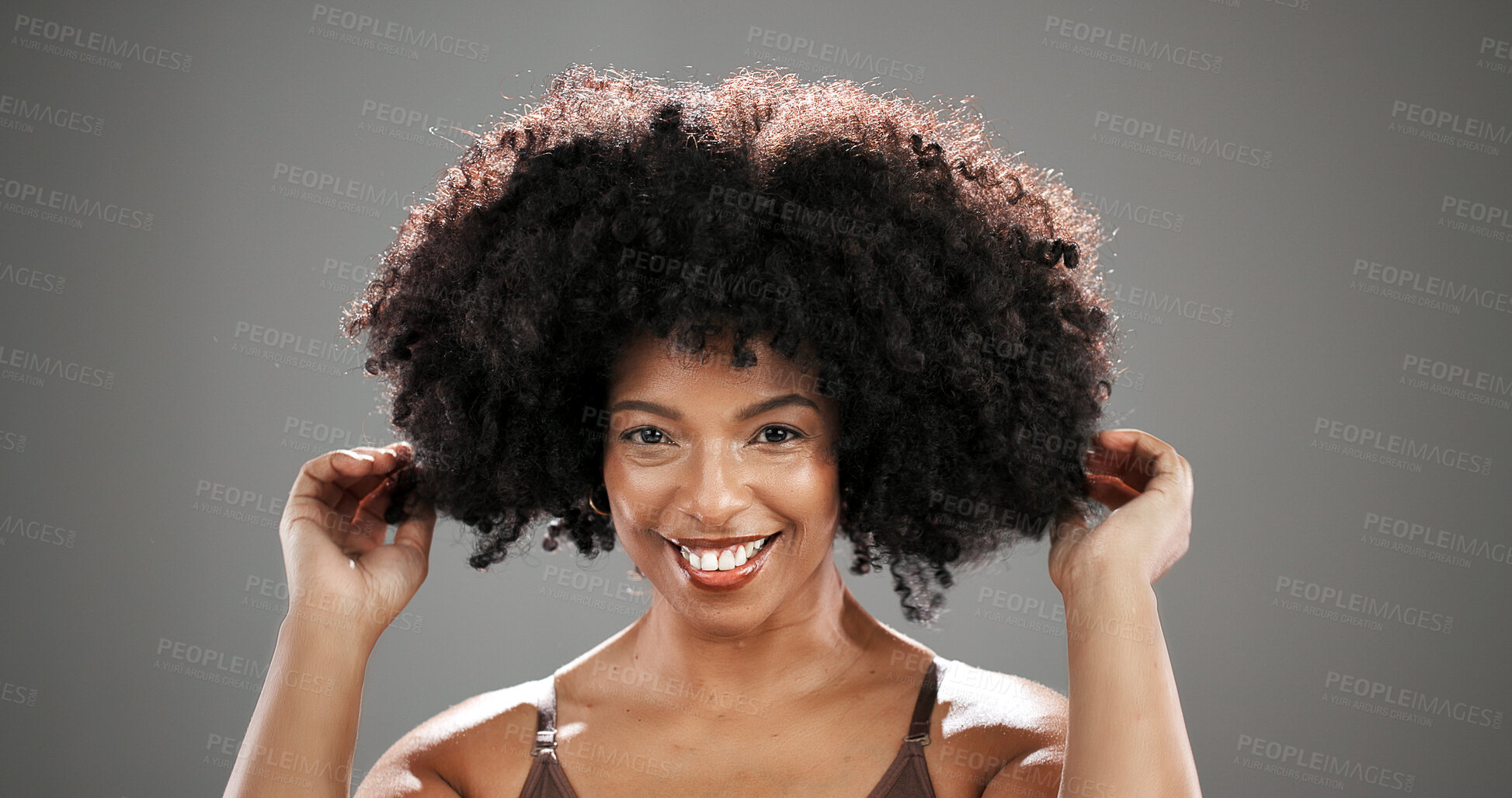 Buy stock photo African woman, hair care and smile in studio portrait with texture, results and keratin by background. Person, happy and growth with afro, confidence and hairstyle with touch for volume in Kenya