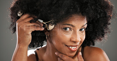 Buy stock photo Woman, skincare and jade roller in studio with facial routine, beauty and anti aging by background. African person, portrait and tools with massage, circulation and product for results in Nigeria