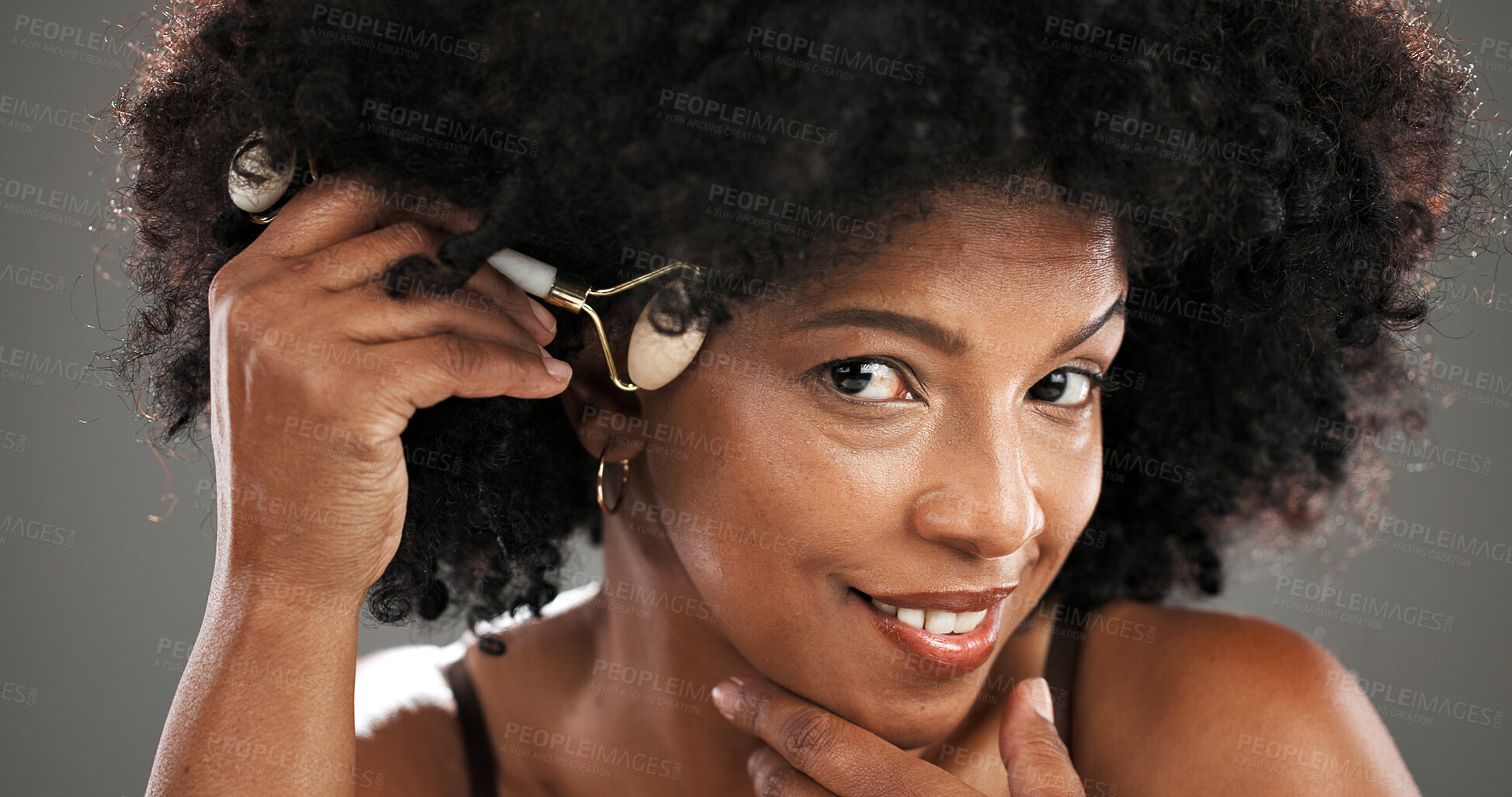 Buy stock photo Woman, skincare and jade roller in studio with facial routine, beauty and anti aging by background. African person, portrait and tools with massage, circulation and product for results in Nigeria