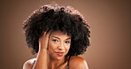 Hair care, happy and portrait of black woman in studio for health, texture and growth on brown background. Aesthetic, mockup space and person with natural hairstyle, afro and beauty for grooming