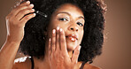Black woman, portrait and apply serum for skincare, dermatology or hyaluronic acid for hydration. Face, model and dropper for cosmetics, collagen treatment or anti aging benefits on studio background