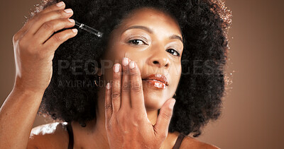 Buy stock photo Black woman, portrait and apply serum for skincare, dermatology or hyaluronic acid for hydration. Face, model and dropper for cosmetics, collagen treatment or anti aging benefits on studio background