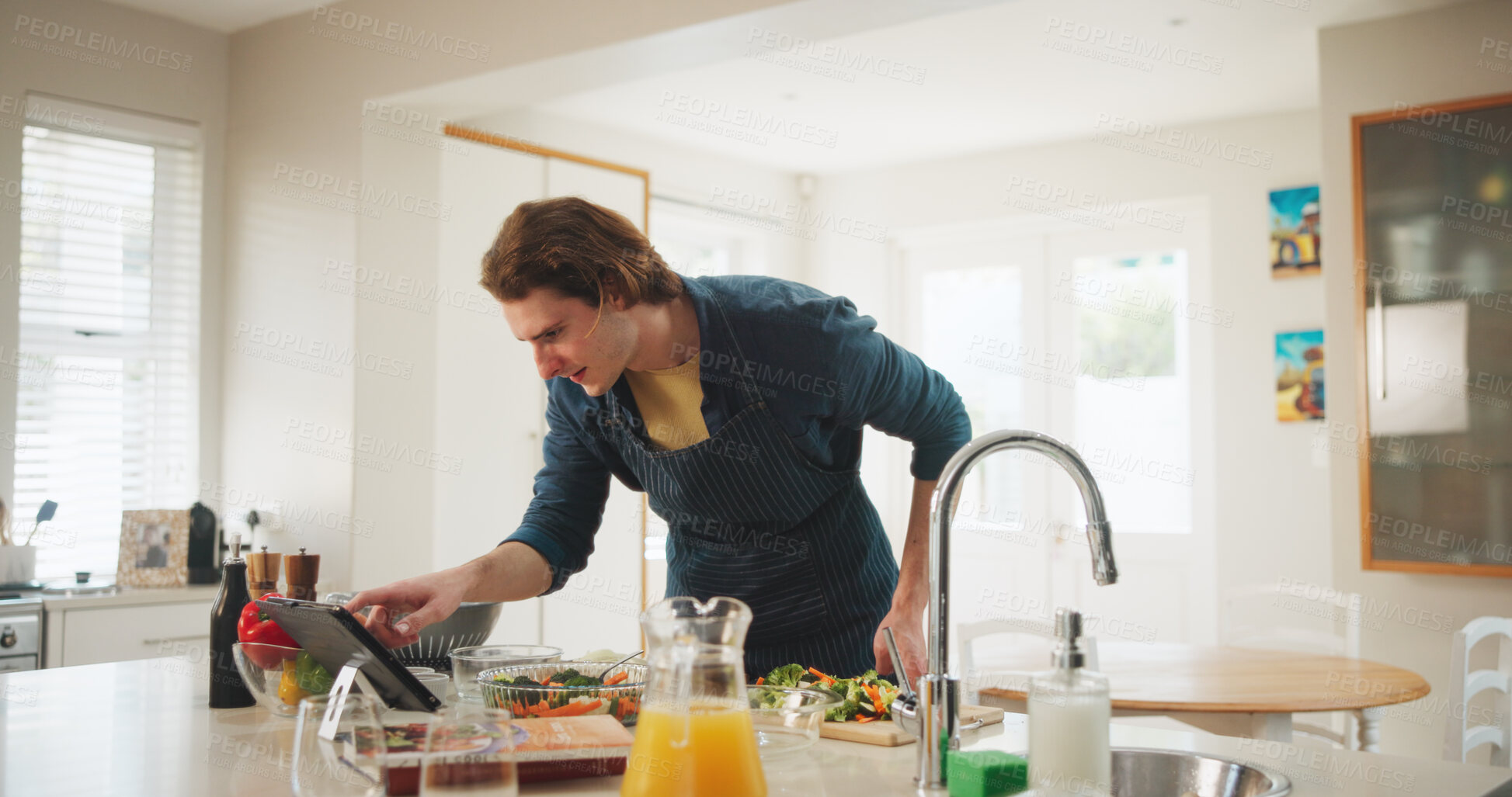 Buy stock photo Home, reading or man on tablet for cooking recipe method, lunch or learning guide in kitchen. Online tutorial, technology or chef on touchscreen with ingredients instruction, food or meal prep steps