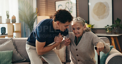Buy stock photo Senior woman, caregiver and help with walking stick on sofa for mobility, assistance and recovery. Health worker, elderly person and support with cane in assisted living for balance or rehabilitation