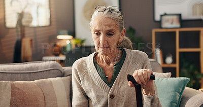 Buy stock photo Home, thinking and senior woman with cane, depression or lonely with loss in living room or sadness. Serious, reflection and old person with walking stick, remember and grief for death in house