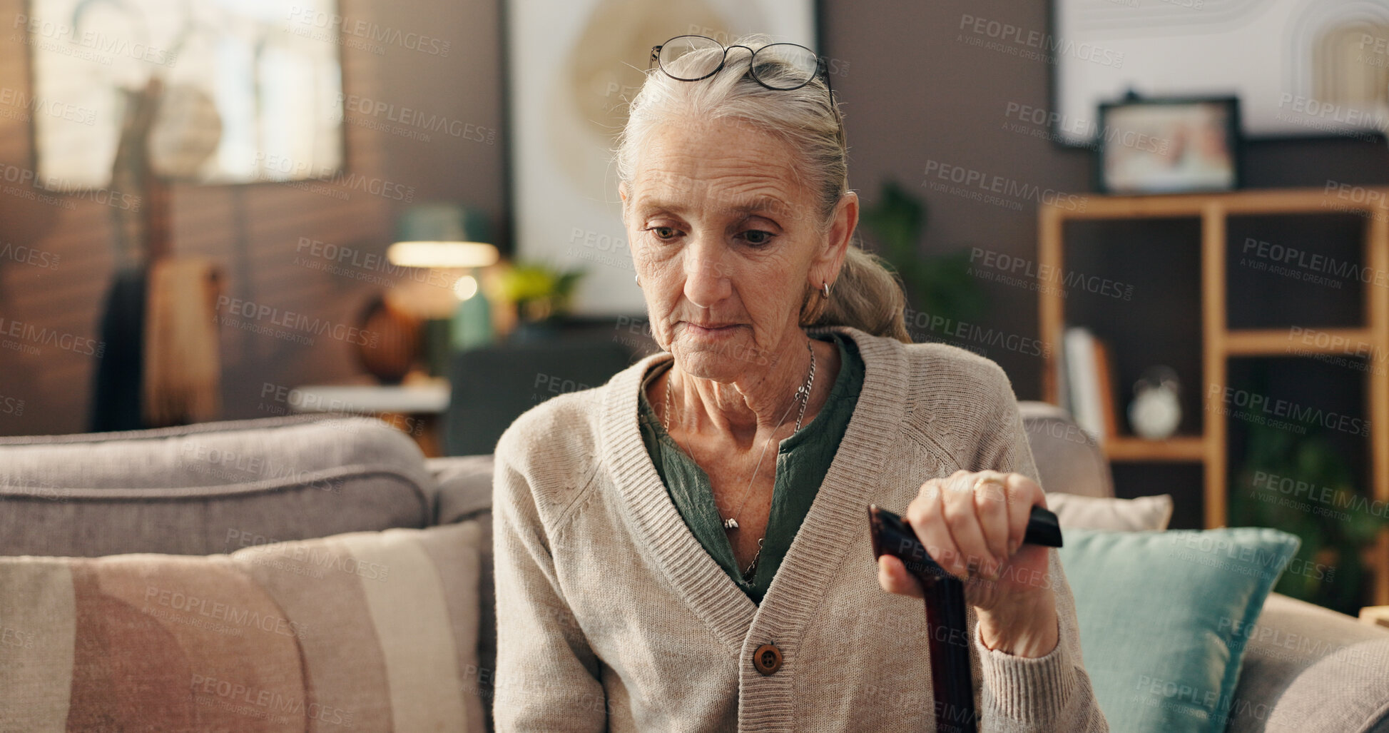 Buy stock photo Home, thinking and senior woman with cane, depression or lonely with loss in living room or sadness. Serious, reflection and old person with walking stick, remember and grief for death in house
