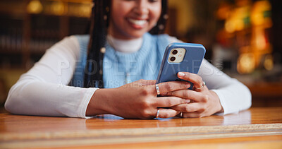 Buy stock photo Hands, phone and texting with app at coffee shop with contact, typing or streaming on web at restaurant. Person, smartphone and click with chat, search and smile with social media at cafeteria
