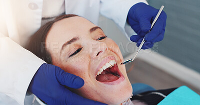 Buy stock photo Dental mirror, consultation and orthodontist with woman for treatment of tooth decay, cavity or oral care. Checkup, health and dentist with female patient for procedure with medical tool in clinic.