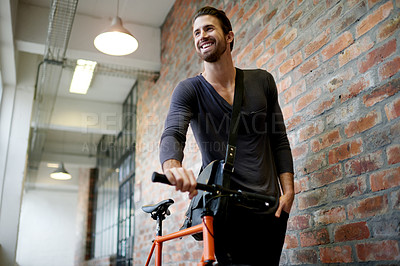 Buy stock photo Walking, bicycle and happy man in startup for creative career, job commute and opportunity ideas. Smile, designer or employee thinking of bike, carbon footprint and travel in hallway in workplace