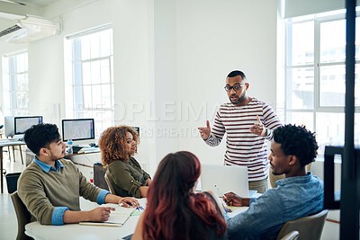 Buy stock photo Shot of a group of colleagues having a meeting in a modern office