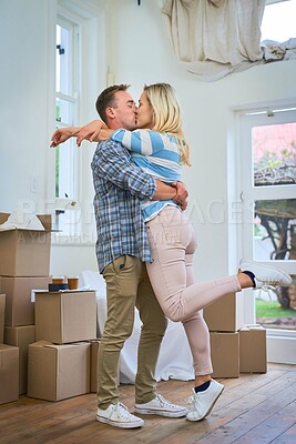 Buy stock photo Moving, couple and kiss for home, box and man in living room, happy and mortgage for real estate in apartment. Woman, new house and property with packages, romance and loan for investment in USA