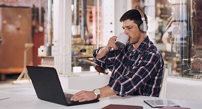 Buy stock photo Laptop, workshop and man with headphones, desk and construction office building. Typing, podcast and technology for work in architecture planning, workplace and internet for male entrepreneur  