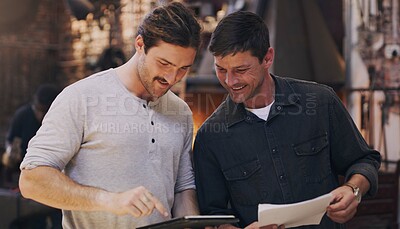 Buy stock photo Tablet, partner and men in workshop for discussion or blacksmith planning in small business startup. Metal work, smile and team in factory on technology, paperwork or collaboration for manufacturing