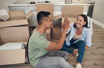 Buy stock photo High five, couple and happy in new home with boxes for moving in, satisfied and celebration with ownership. House, relationship and smile with unpacking furniture, excited and positive with property