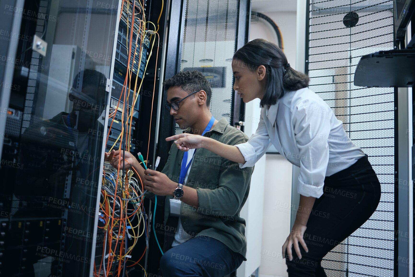 Buy stock photo IT people, engineer or server room cable for programming or connection maintenance. Man and woman technician in datacenter for network, cybersecurity software or data center problem or system upgrade