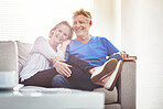 Happy mature couple relaxing together on a sofa at home