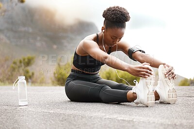 Buy stock photo Fitness, black woman or stretching legs in road for running, workout or training at sunset with music or water. Exercise, wellness or runner streaming podcast with body warm up for sports performance