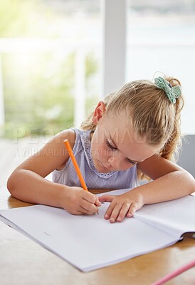 Buy stock photo Education, art and girl learning to draw at a table, having fun with colors and paper sketch in her home. Growth, development and creative activity for young learner looking serious about picture