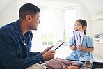 Happy father, child and tickets for flight, travel or holiday vacation together at home. Excited little girl and dad packing for weekend trip or getaway in celebration with boarding pass in the house