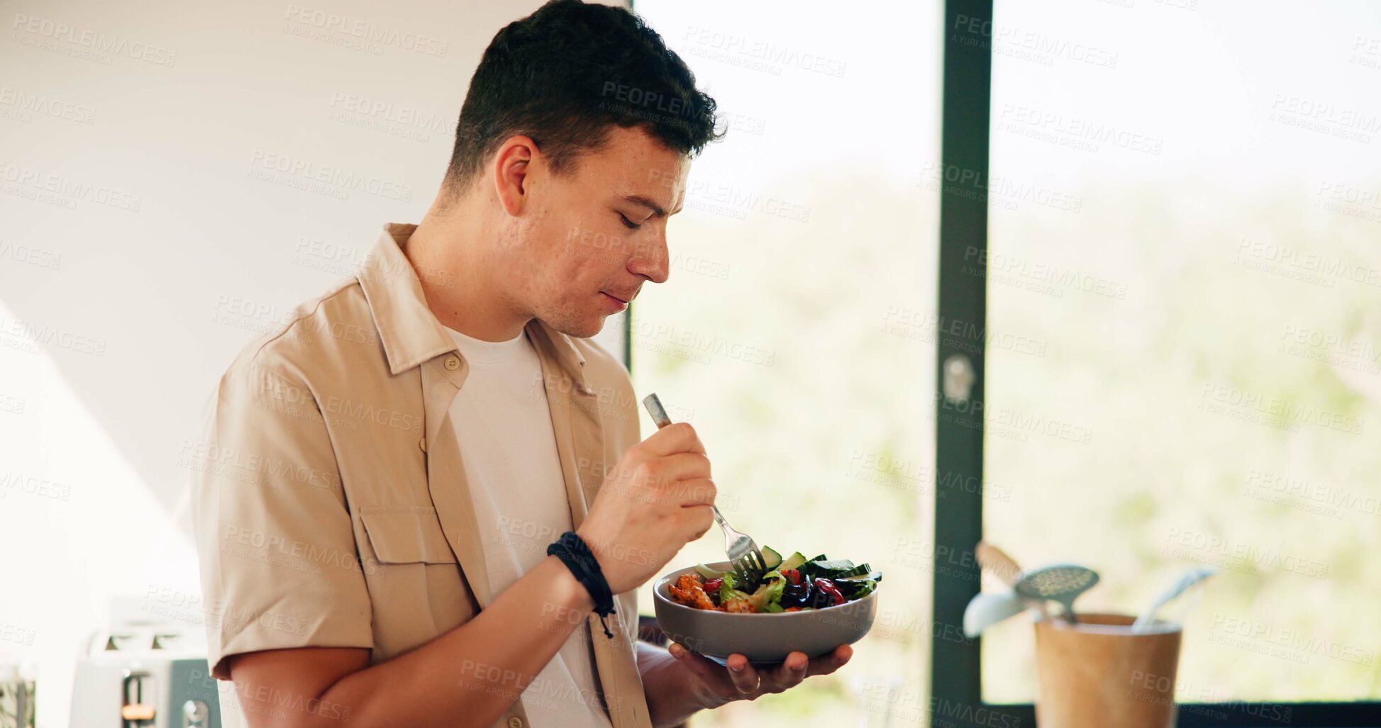 Buy stock photo Nutrition, eating and man with breakfast in kitchen in morning for organic bowl. Vegan, health and male person enjoying fruit salad for snack, lunch or craving on diet, vitamins or wellness in home.