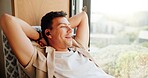 Man, earphones and relax by window in home with smile, memory and reflection with music in morning. Person, ear pods and happy with audio streaming, subscription and thinking on couch at apartment
