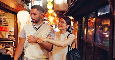 Buy stock photo Street food, night and pointing of Japanese couple at market for culture festive, nutrition or health. Travel, shopping and cuisine with man and woman at Japan city vendor for date and holiday