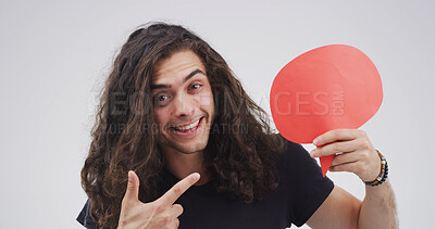 Buy stock photo Blank sign, pointing and portrait of man in studio with feedback, announcement or vote. Social media, mockup space and person from Portugal with text box, speech bubble or placard by white background