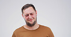 Sad, depression and man in studio with stress for grief, broken heart or disaster on white background. Anxiety, unhappy and person with mental health crisis, bad news and  loneliness with space
