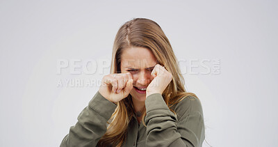 Buy stock photo Woman, crying and depression in studio with stress, wipe tears or grief for loss on white background. Person, mental health and mock up space with broken heart, frustrated and anxiety with trauma