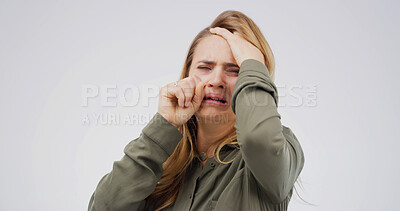 Buy stock photo Woman, crying and depression in studio with grief, wipe tears or stress for loss on white background. Person, mental health and mock up space with broken heart, frustrated and anxiety with trauma