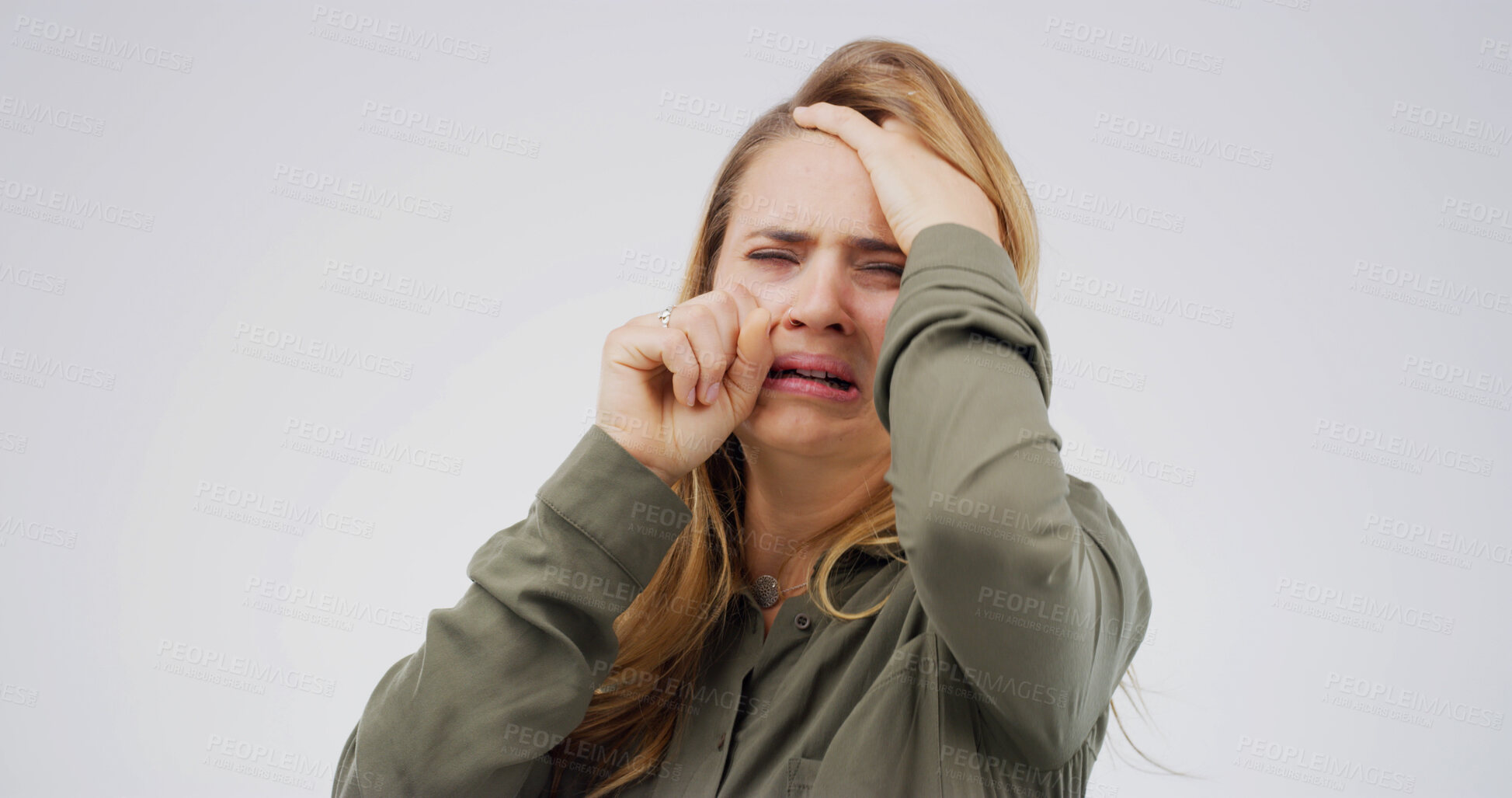Buy stock photo Woman, crying and depression in studio with grief, wipe tears or stress for loss on white background. Person, mental health and mock up space with broken heart, frustrated and anxiety with trauma