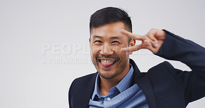 Buy stock photo Portrait, peace sign and man in studio, business and confident personality on white background. Asian person, employee and space with gesture, feedback and support with icon, v symbol and promotion
