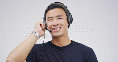 Buy stock photo Asian man, portrait and headset in studio for telemarketing, sales and insurance advice in call center. Agent, tech and communication on white background for consult, business contact us or CRM
