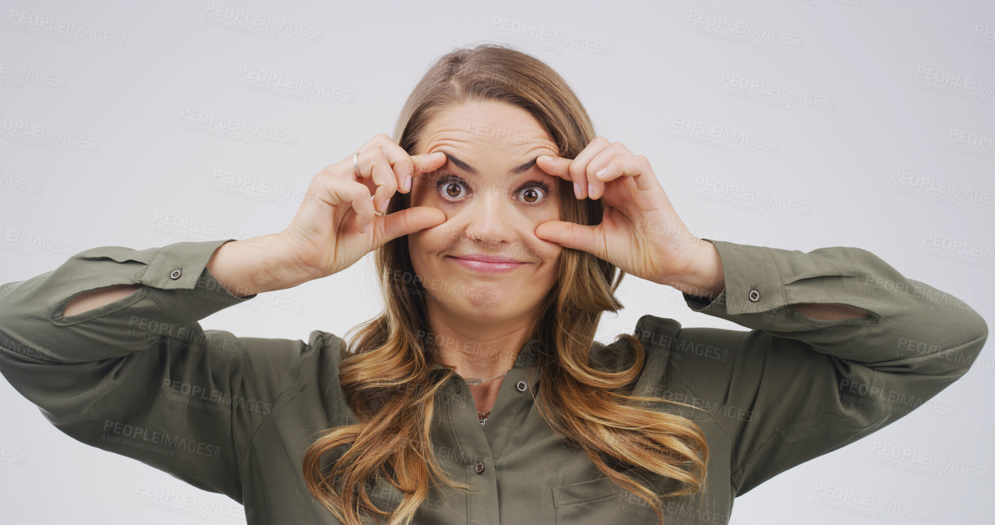 Buy stock photo Goofy, funny face and portrait of woman in studio with open eyes, silly and comic facial expression. Crazy, joke and female person from Canada with comedy gesture for humor by white background.