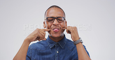 Buy stock photo Funny face, glasses and tongue out with black man in studio for comic, meme or joke. Facial expression, comedy and happiness with person on white background space for good mood, goofy and silly emoji