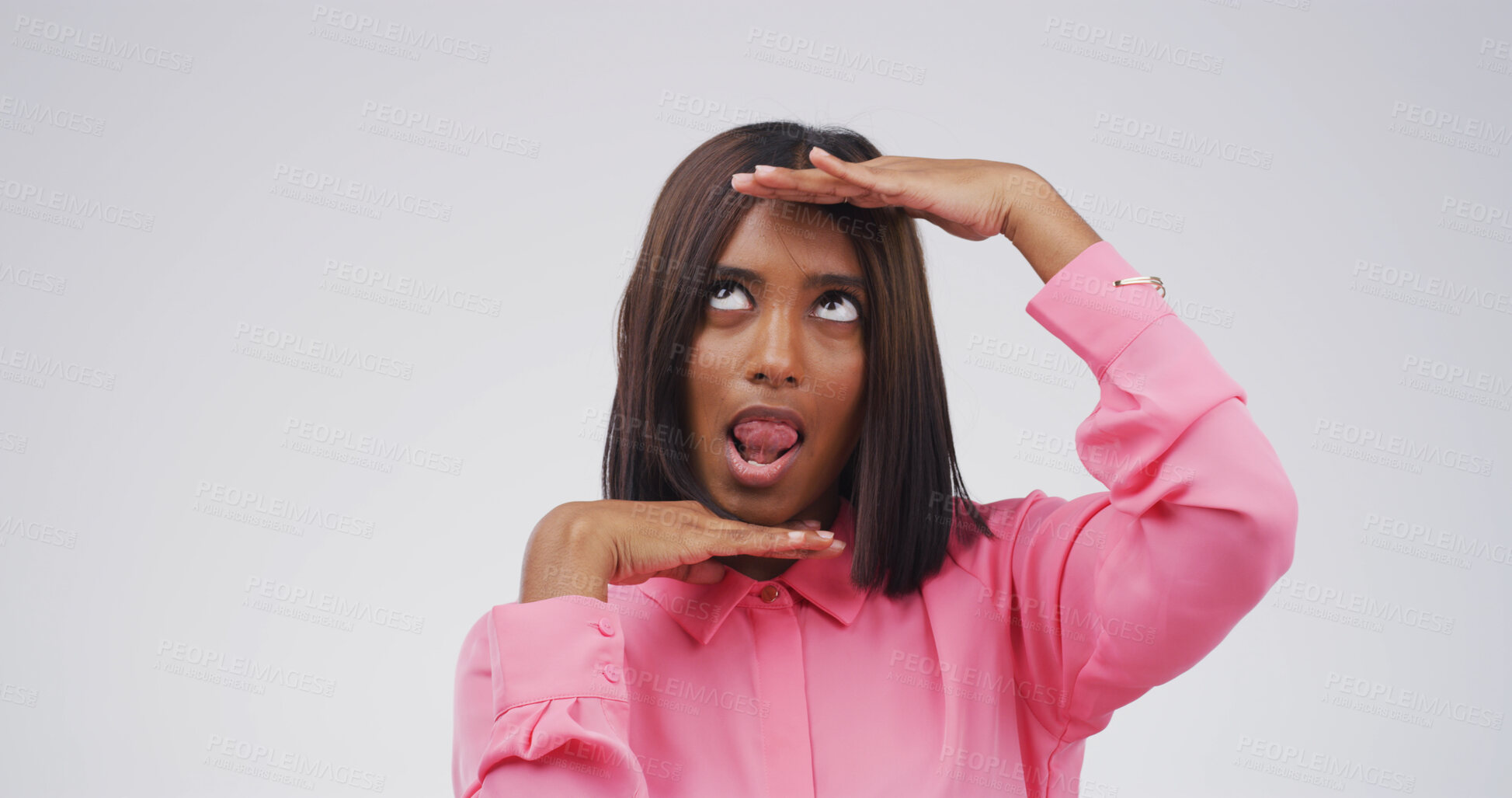 Buy stock photo Hand frame, silly and woman in studio for funny face, humor and comedy on white background. Looking up, mockup space and isolated person with reaction, facial expression and emoji for goofy joke