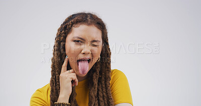 Buy stock photo Girl, funny face and tongue out in studio with wink, playful and mock up space on white background. Woman, comic expression and silly portrait with mouth, flirt and humor with emoji in Colombia