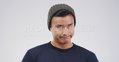 Buy stock photo Silly, crazy and Asian man in studio with funny face for playful, comedy and humor on white background. Mockup space, weird and isolated person with goofy, quirky and facial expression for reaction