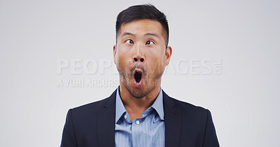 Buy stock photo Asian man, funny face or silly with goofy attitude for monkey business on a white studio background. Businessman, model or humor with comic expression for joke, comedy or clown on mockup space