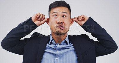 Buy stock photo Silly man, goofy and funny face with ears in studio for monkey business on a white background. Male person, employee or model with playful attitude, comic or behaviour for joke, humor or comedy