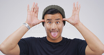 Buy stock photo Silly man, portrait and funny face with ears in studio for joke or comedy on a white background. Male person, goofy or model with playful attitude, comic or behaviour for silly, fool or bamboozle