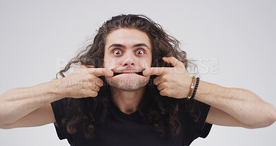 Buy stock photo Funny face, stretching and portrait of man in studio for theater prep, facial exercise and comic. Actor warm up routine, expression and muscle technique with person on white background for practice