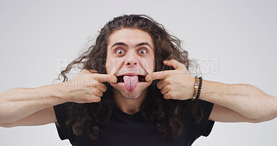 Buy stock photo Tongue out, stretching and portrait of man in studio for theater practice, facial exercise and funny face. Actor warm up routine, expression and performance technique with person on white background