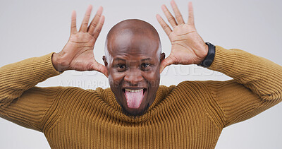 Buy stock photo Funny face, portrait and tongue out with black man in studio for comic, meme or joke. Facial expression, comedy and happiness with person on white background for good mood, goofy or silly emoji